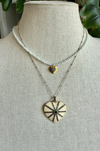 Necklace of two-tone silver and gold bead chain with cream enamel and pave diamond heart pendant