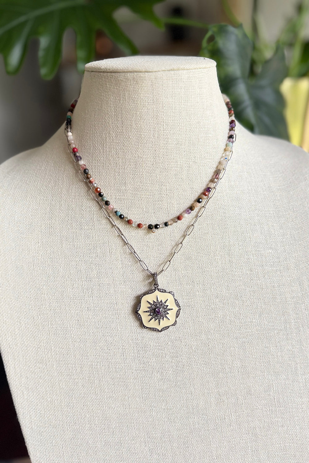 Necklace of oxidized sterling cable chain with cream enamel, and pave diamond pendant