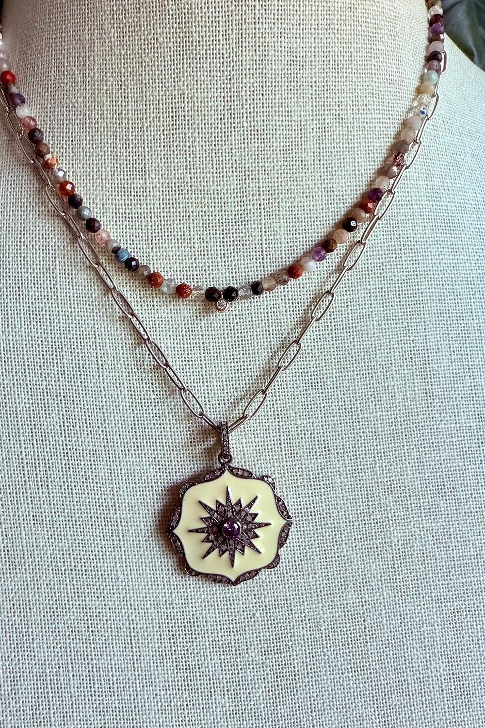 Necklace of oxidized sterling cable chain with cream enamel, and pave diamond pendant